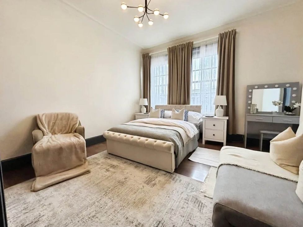 A bedroom with a bed and nightstands at 3 Bedrooms in Central Tunbridge Wells