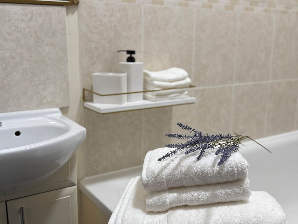 A bathroom with sink, towels, soap dispenser, and tissue box at 3 Bedrooms in Central Tunbridge Wells Royal Tunbridge Wells