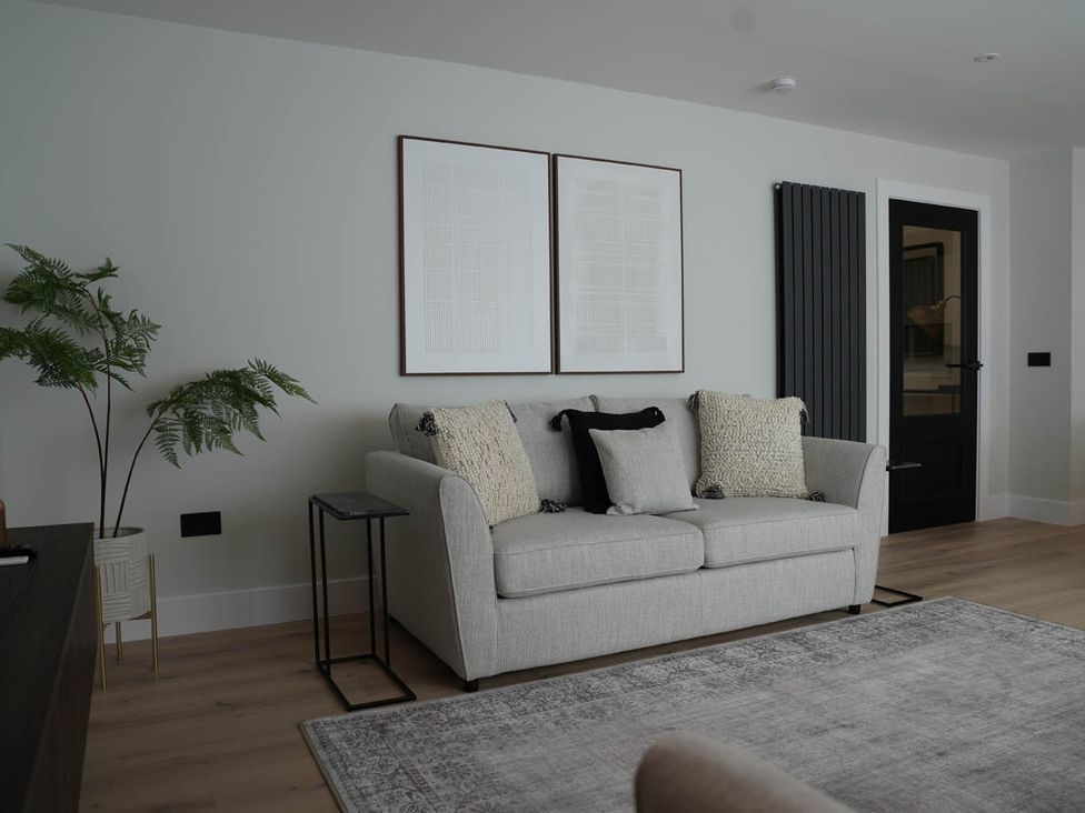 A living room with a sofa and artwork on the wall at 1st Floor Luxury 2Bed Apt Sleeps 6 in St Andrews