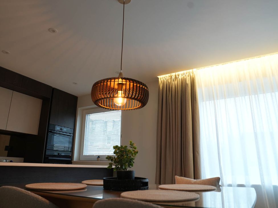 A dining room with a lamp and a plant at 1st Floor Luxury 2Bed Apt Sleeps 6 St Andrews