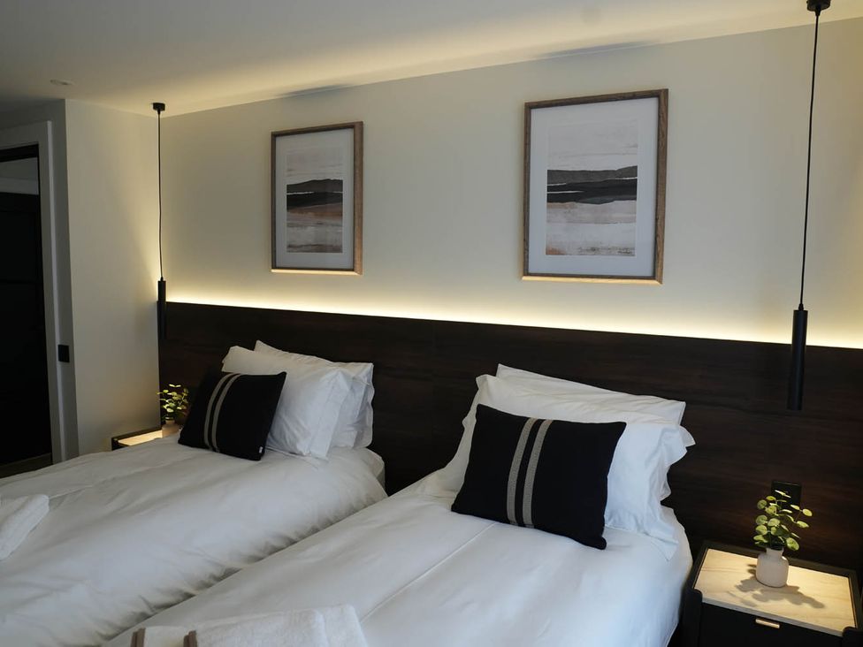 A bedroom with two beds and wall art at 1st Floor Luxury 2Bed Apt Sleeps 6 St Andrews