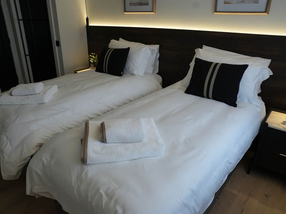 A bedroom with two single beds and towels at 1st Floor Luxury 2Bed Apt Sleeps 6 St Andrews