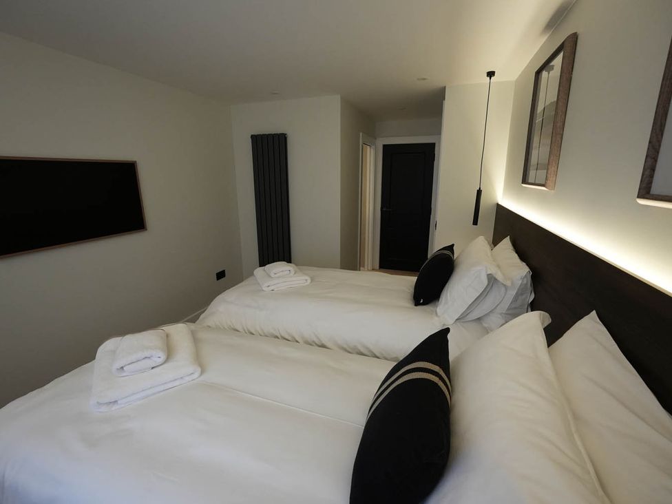 A bedroom with two beds and towels at 1st Floor Luxury 2Bed Apt Sleeps 6 St Andrews
