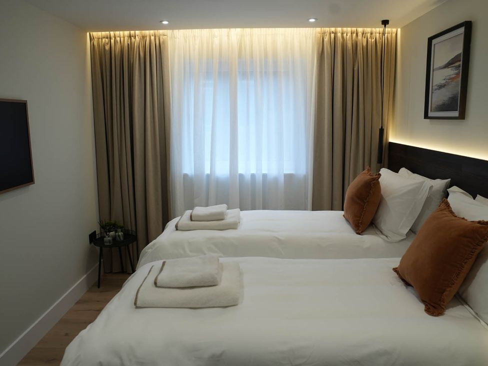 A bedroom with two beds and a window at 1st Floor Luxury 2Bed Apt Sleeps 6 St Andrews