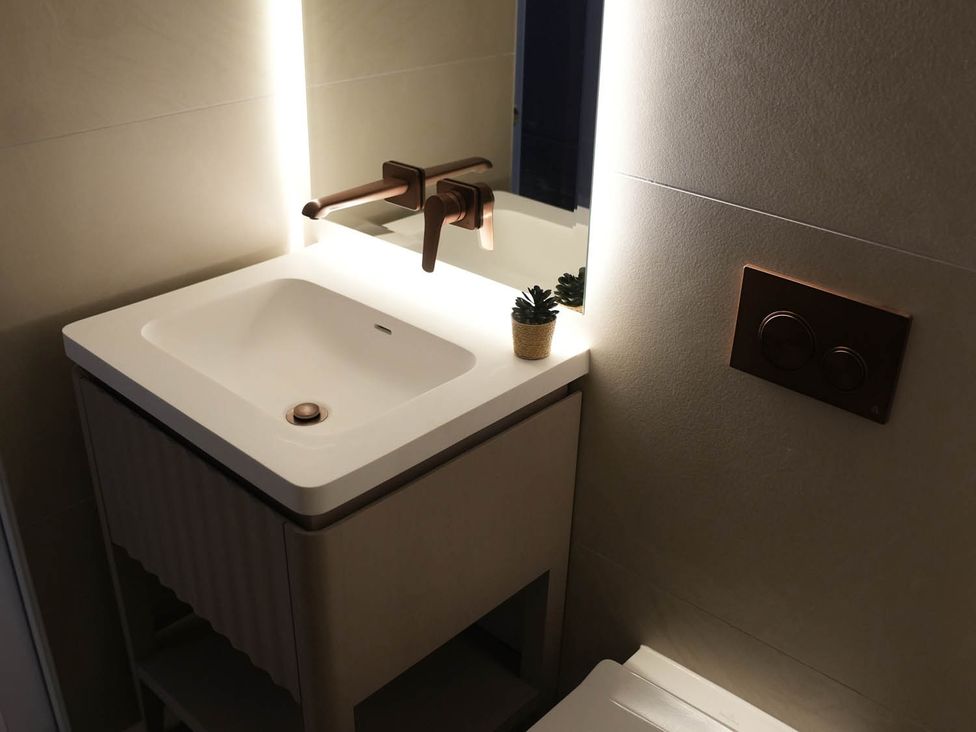 A sink with a faucet and a small plant in a bathroom at 1st Floor Luxury 2Bed Apt Sleeps 6 St Andrews