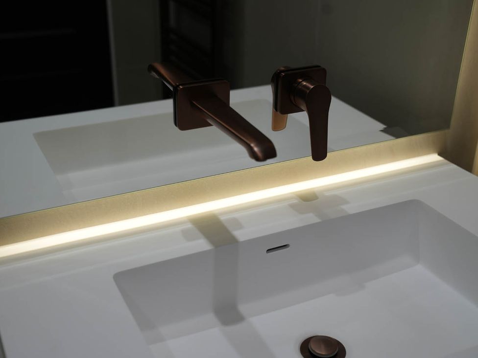 A sink with faucet and mirror at 1st Floor Luxury 2Bed Apt Sleeps 6 St Andrews
