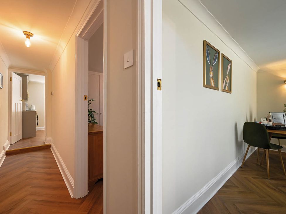 A hallway featuring a light fixture and wall art at 1 Bed Sleeps 2 Near Beach Parking, Hastings