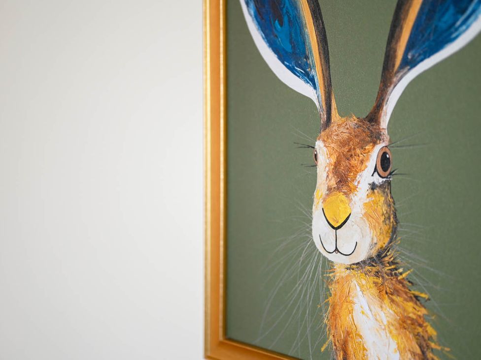 A rabbit painting in a frame on a green background at 1 Bed  Sleeps 2  Near Beach Parking Hastings