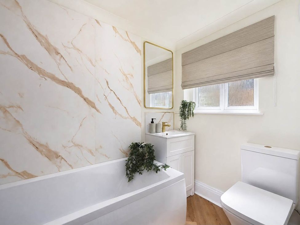 A bathroom with a bathtub, toilet, sink and mirror at 1 Bed  Sleeps 2  Near Beach Parking Hastings