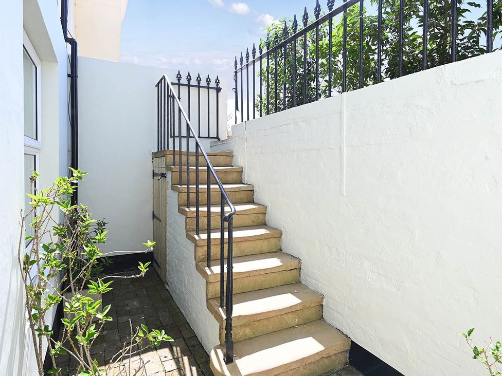 An outdoor stairway with wrought iron railings at 1 Bed Sleeps 2 Near Beach Parking Hastings