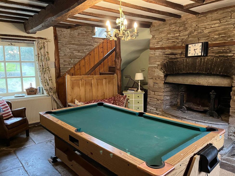 A snug with a pool table and fireplace at The Hills Farmhouse 6 Bed Sleeps 11 Pets Llanfilo near Talgarth
