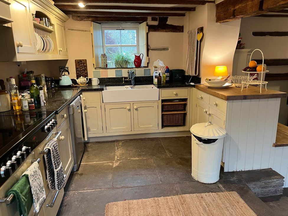 A kitchen with a sink and stove at The Hills Farmhouse 6 Bed Sleeps 11 Pets Llanfilo near Talgarth