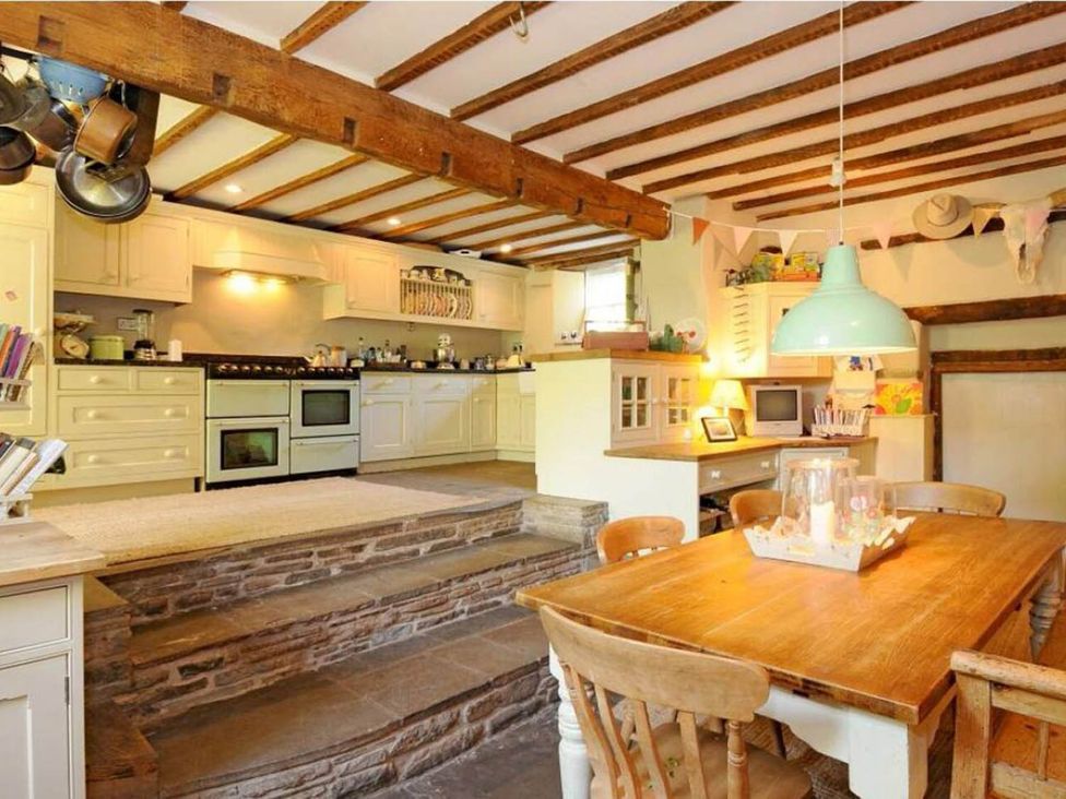 A kitchen with dining table and chairs at The Hills Farmhouse 6 Bed Sleeps 11 Pets Llanfilo near Talgarth