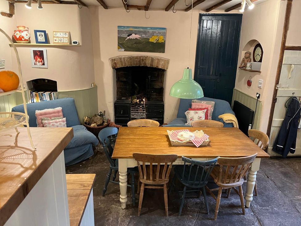 A dining room with a table and chairs at The Hills Farmhouse 6 Bed Sleeps 11 Pets Llanfilo near Talgarth
