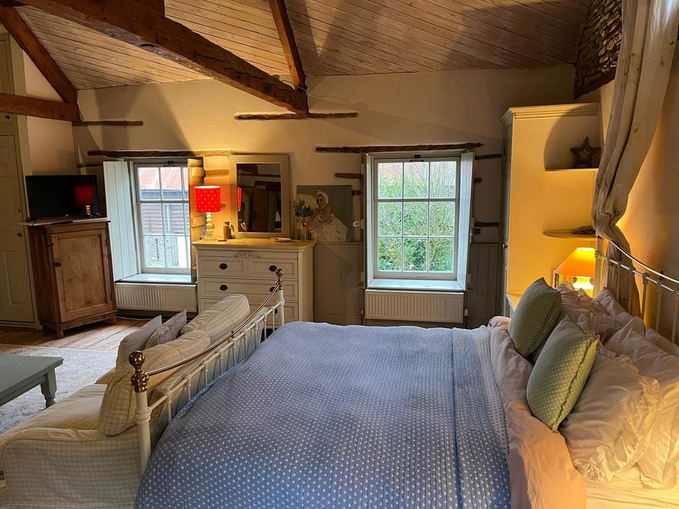 A bedroom with a bed and window at The Hills Farmhouse 6 Bed Sleeps 11 Pets Llanfilo near Talgarth