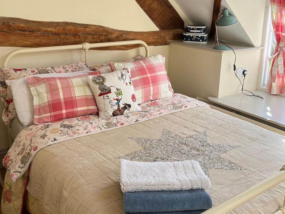 A bedroom with a bed and pillows at The Hills Farmhouse 6 Bed Sleeps 11 Pets Llanfilo near Talgarth