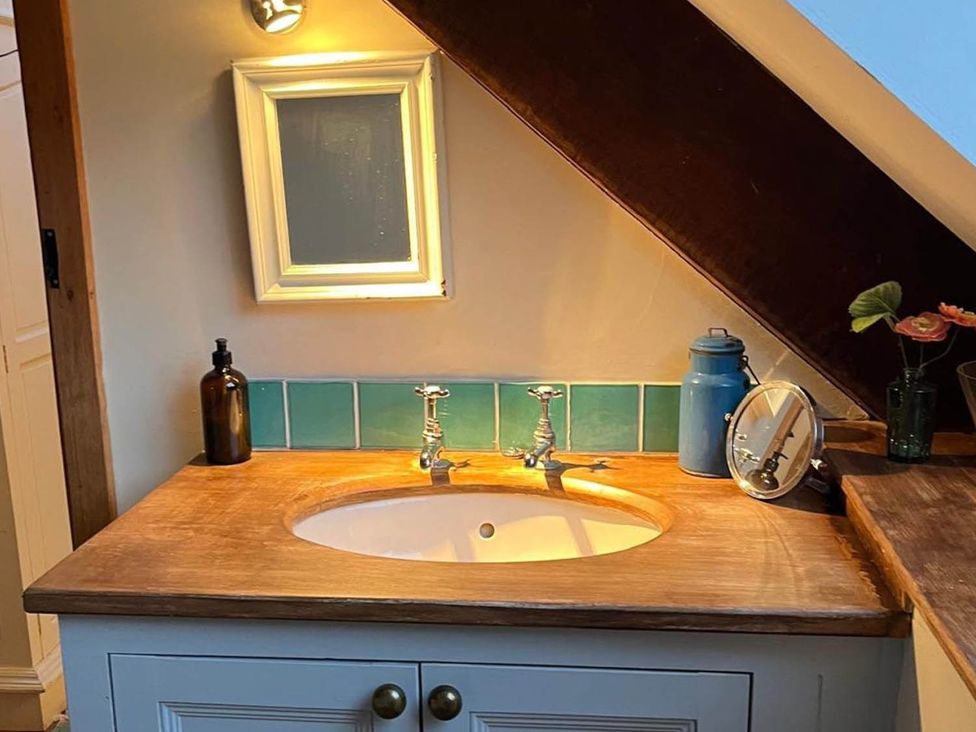 A bathroom with a sink and faucet at The Hills Farmhouse 6 Bed Sleeps 11 Pets in Llanfilo near Talgarth