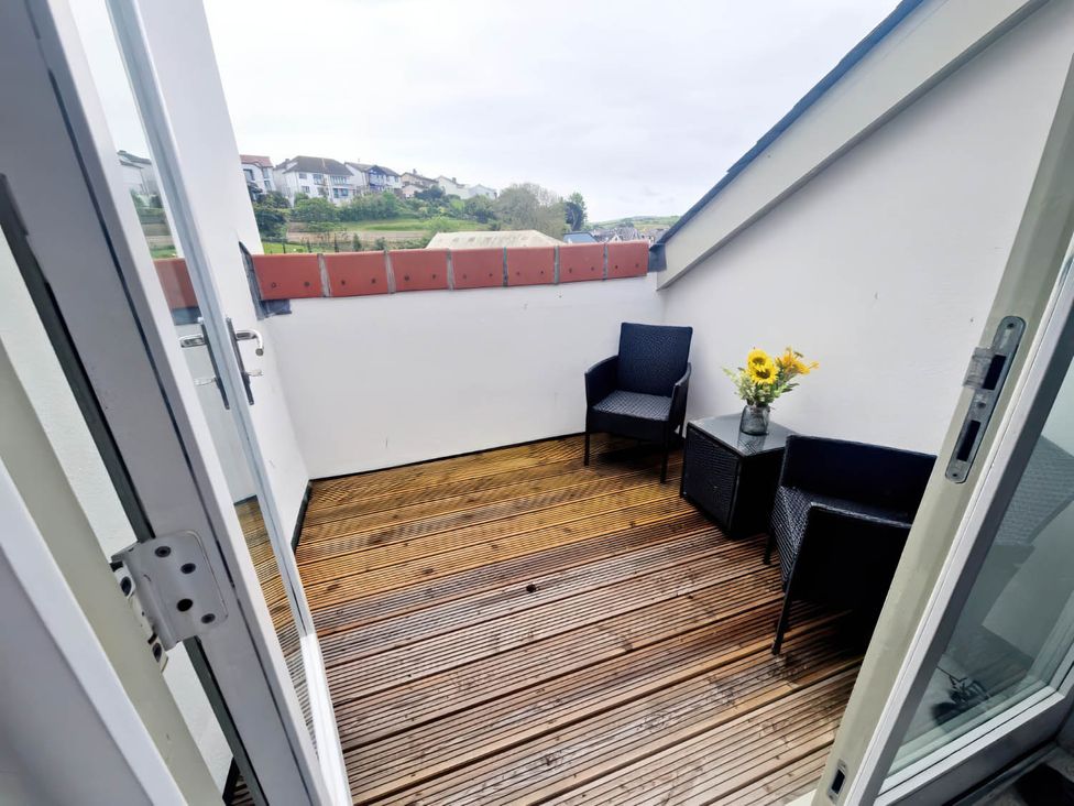 A balcony with two chairs and a table at Apartment Sleeps 4 with Balcony and Parking in Kingsbridge