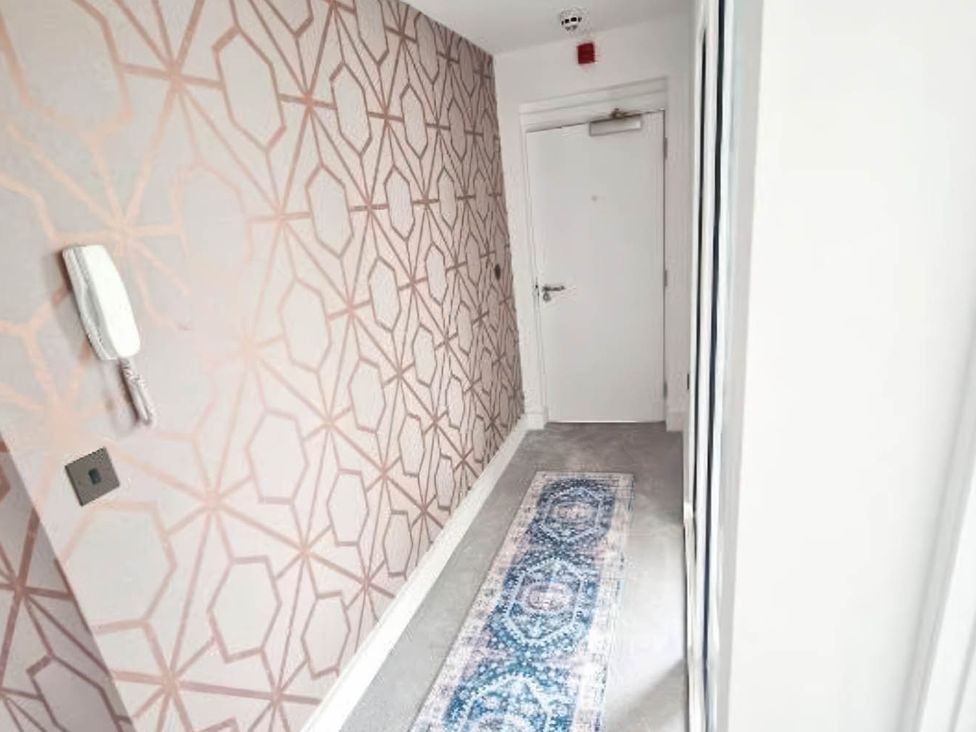 A hallway with a patterned wall and a door at Apartment Sleeps 4 with Balcony and Parking in Kingsbridge