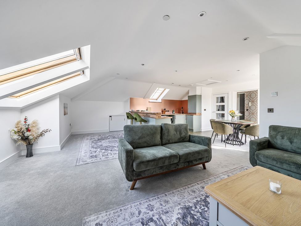 A living room with a sofa and dining area at Apartment Sleeps 4 with Balcony and Parking in Kingsbridge