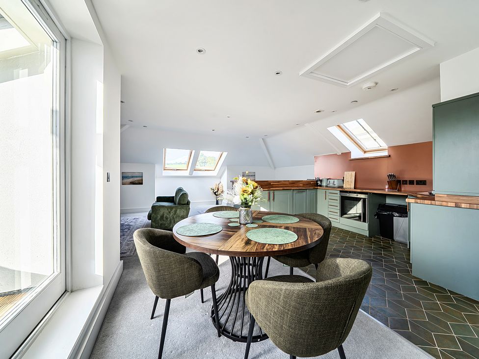A kitchen with a dining table and chairs at Apartment Sleeps 4 with Balcony and Parking in Kingsbridge