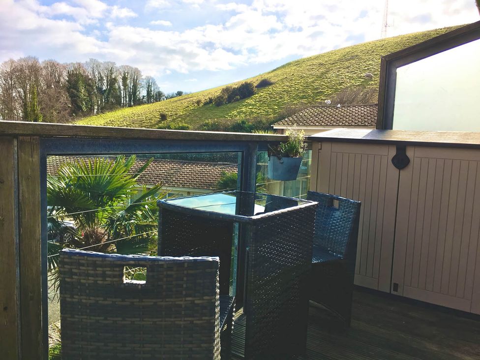A balcony with table and chairs at Torpoint Apartment Sleeps4 Seaside Parking in Downderry