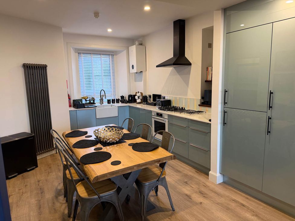A kitchen with a table and chairs at Seaview Apartment 2Bed on Anstruther Harbour in Anstruther