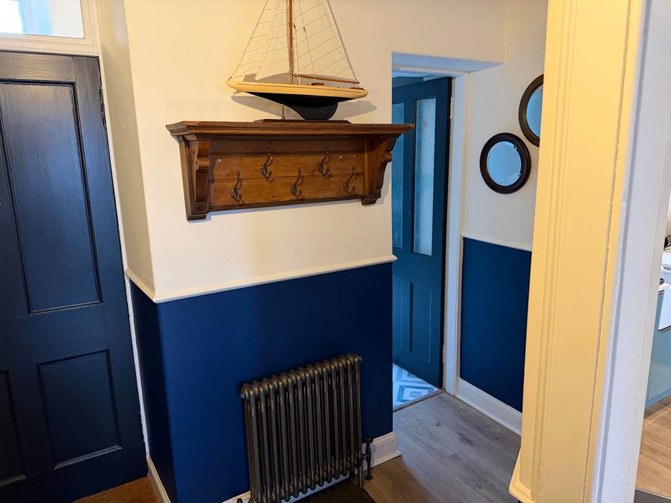 A hallway with coat hooks and a sailboat at Seaview Apartment 2Bed on Anstruther Harbour Anstruther