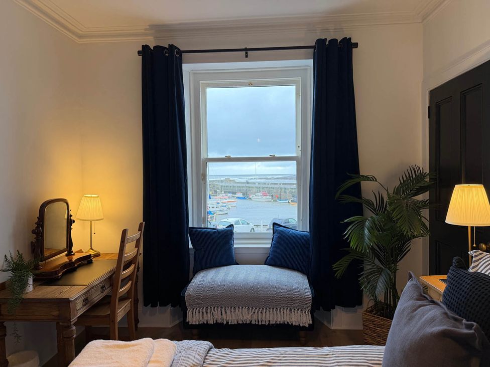 A bedroom with a window and desk at Seaview Apartment 2Bed on Anstruther Harbour Anstruther