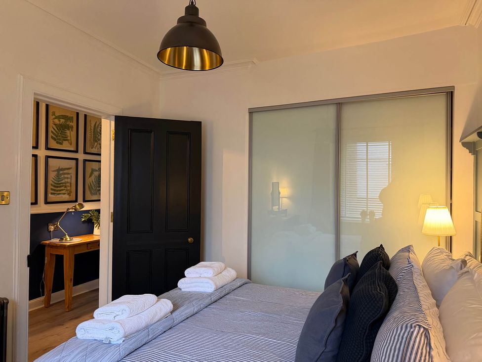 A bedroom with a bed and desk at Seaview Apartment 2Bed on Anstruther Harbour Anstruther