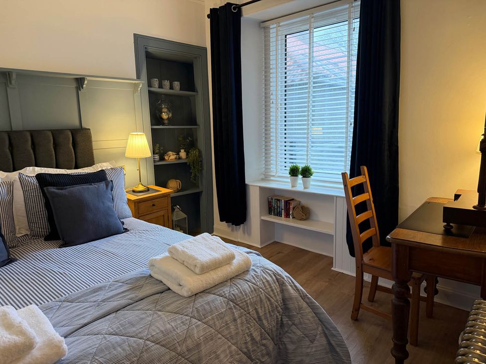A bedroom with a bed and desk at Seaview Apartment 2Bed on Anstruther Harbour Anstruther