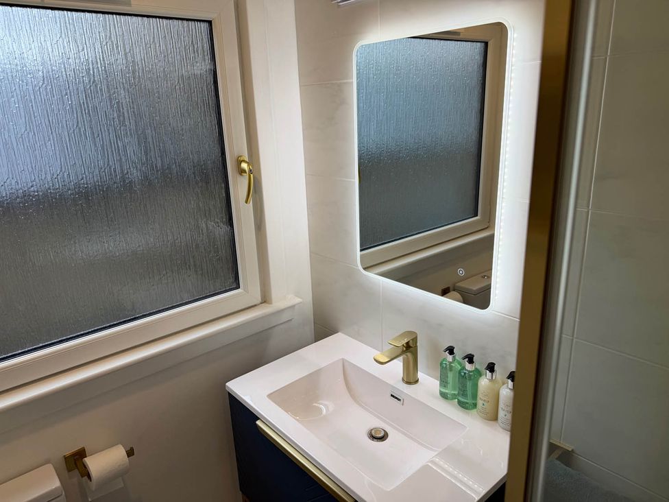 A bathroom with a sink and mirror at Seaview Apartment 2Bed on Anstruther Harbour