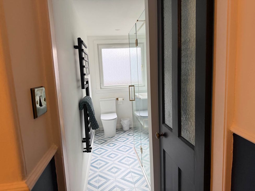 A bathroom with a toilet, sink, and shower at Seaview Apartment 2Bed on Anstruther Harbour Anstruther