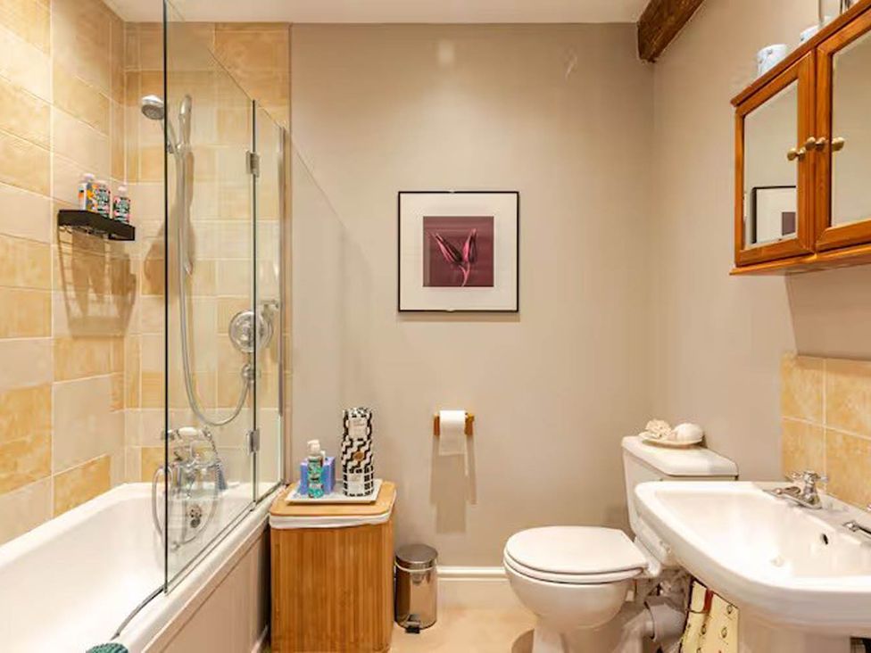 A bathroom with a sink, toilet, shower, and bathtub at Dowgill 3Bed Barn Sleeps 7 Hot Tub Parking Near Summerbridge