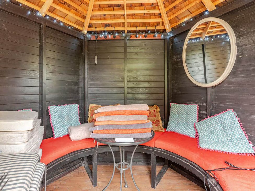 A snug area with cushions and a table at Dowgill 3Bed Barn Sleeps 7 Hot Tub Parking near Summerbridge