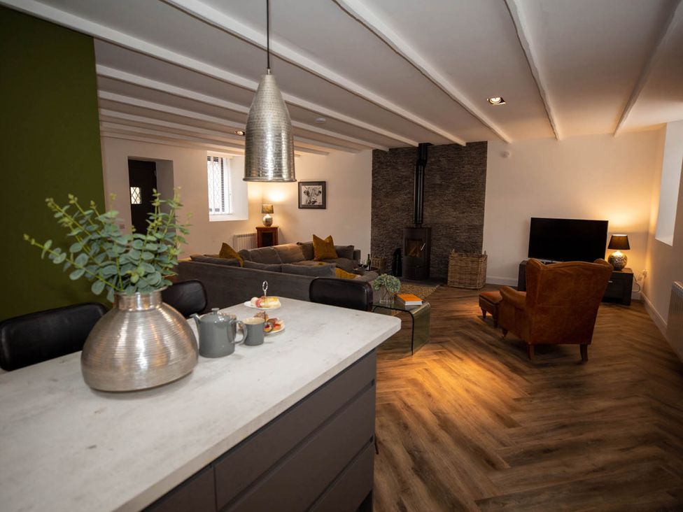 A living room with a sofa, coffee table, and television at Stunning 3 Bed Converted Village Hall Near Kelso Nenthorn near Kelso