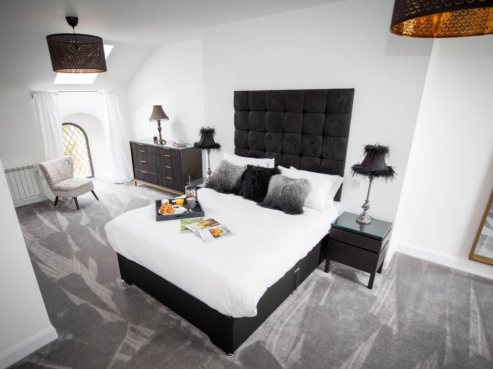 A bedroom with a bed and a window at Stunning 3 Bed Converted Village Hall Near Kelso Nenthorn near Kelso