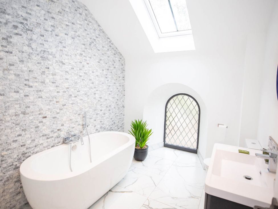 A bathroom with a bathtub and sink at Stunning 3 Bed Converted Village Hall Near Kelso Nenthorn near Kelso
