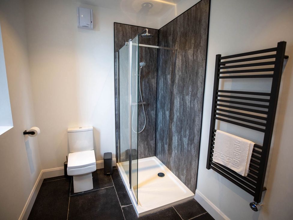 A bathroom with a shower and toilet at Stunning 3 Bed Converted Village Hall Near Kelso