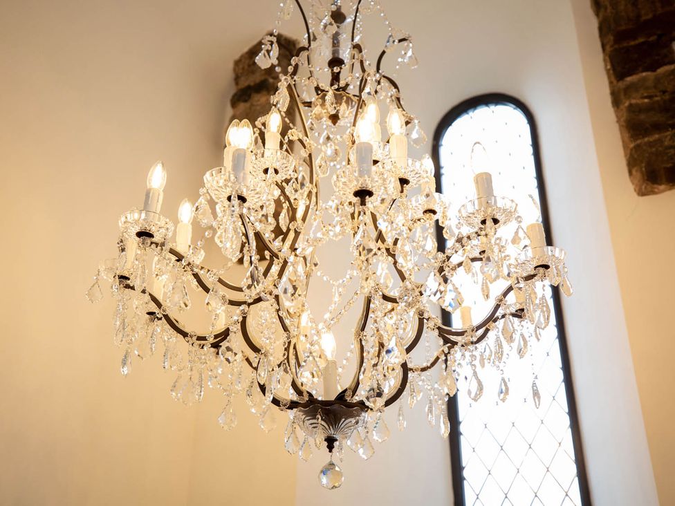 A chandelier with light bulbs and crystals
