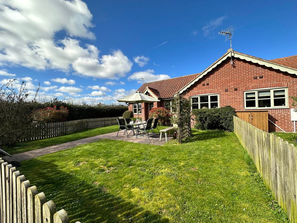 A house with a garden and patio furniture at Cottage Sleep 4 Pet Friendly Enclosed Garden in Rollesby, near Scratby