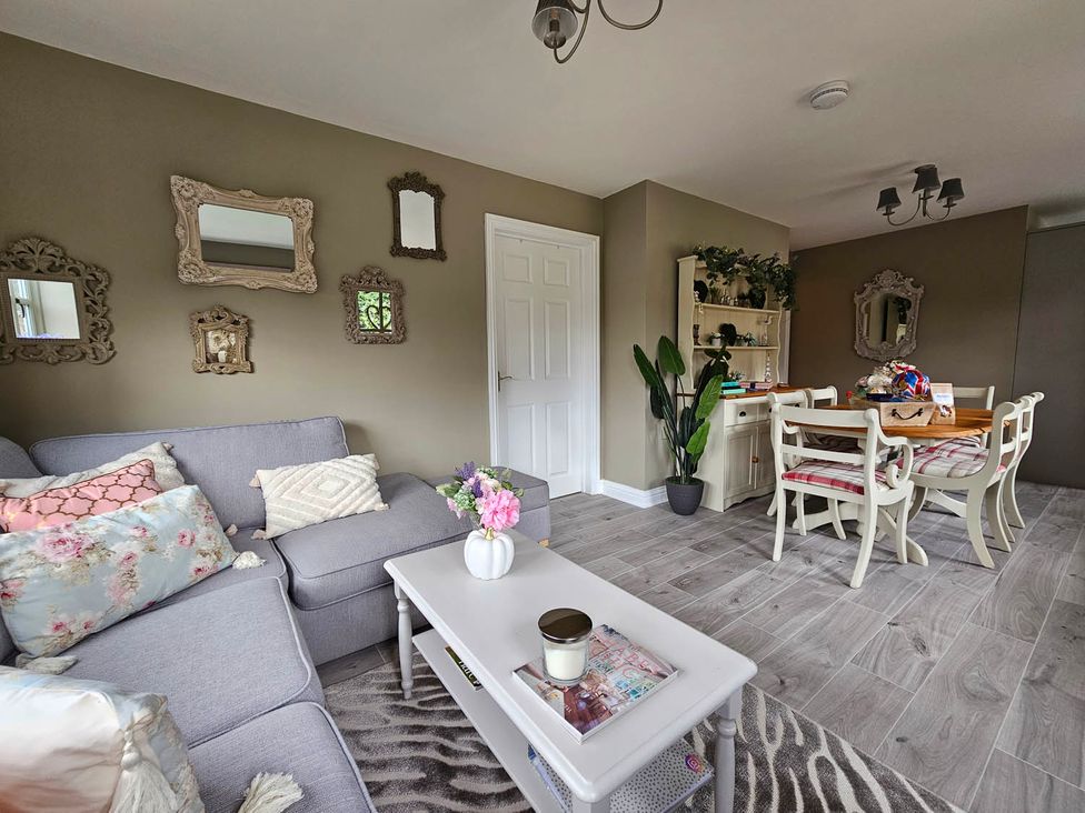 A living room with a sofa and dining area at Cottage Sleep 4 Pet Friendly Enclosed Garden Rollesby, near Scratby