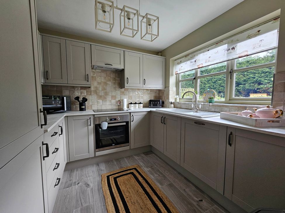 A kitchen with cabinets and appliances at Cottage Sleep 4 Pet Friendly Enclosed Garden in Rollesby, near Scratby