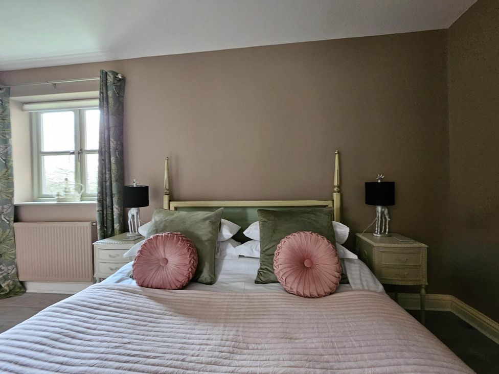 A bedroom with a bed, bedside tables, and a window at Cottage Sleep 4 Pet Friendly Enclosed Garden Rollesby, near Scratby