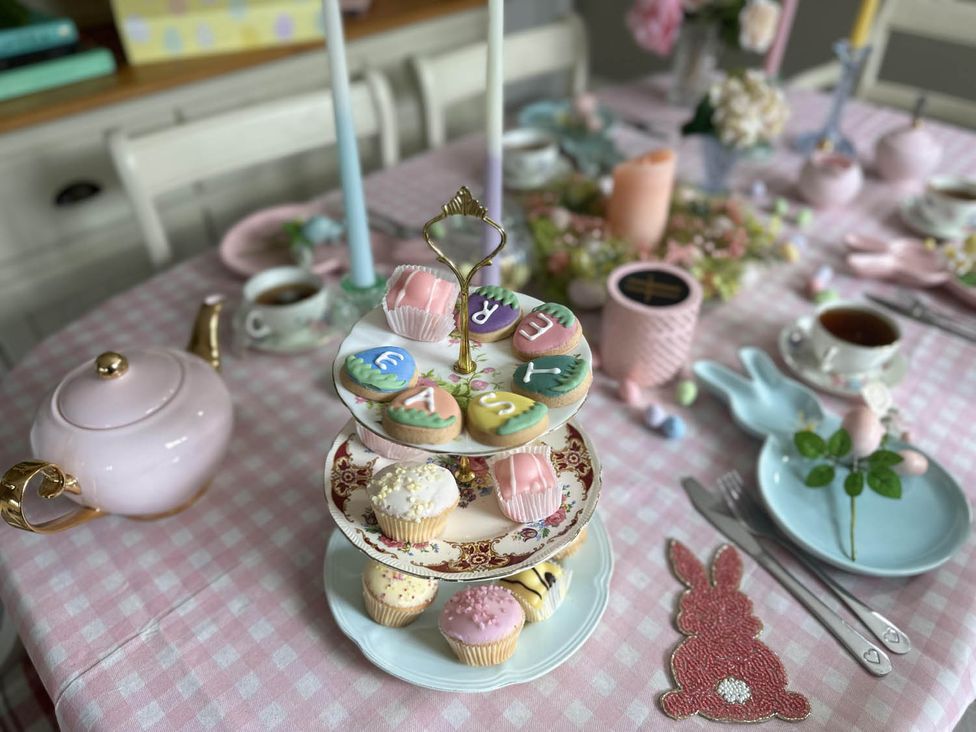 A dining table with desserts and a teapot at Cottage Sleep 4 Pet Friendly Enclosed Garden, Rollesby, near Scratby