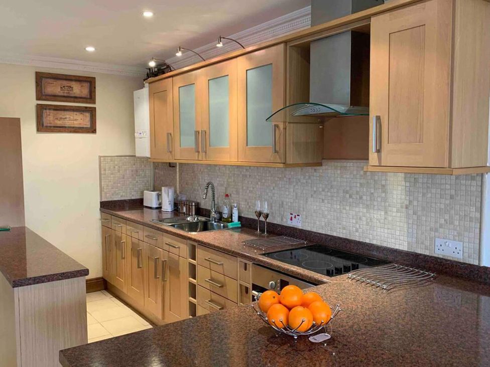 A kitchen with cabinets and a sink at 2Bedroom Cottage with 2 Ensuites Sleeps 6 Wifi Near Rye