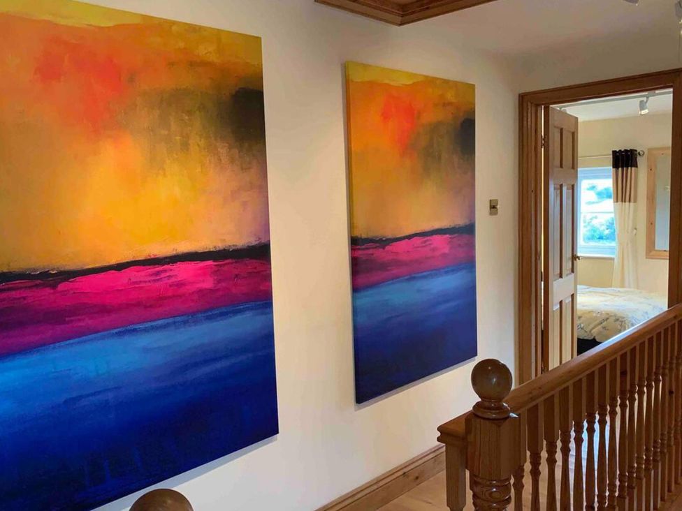 A hallway with two paintings and a door at 2Bedroom Cottage with 2 Ensuites Sleeps 6 Wifi Near Rye