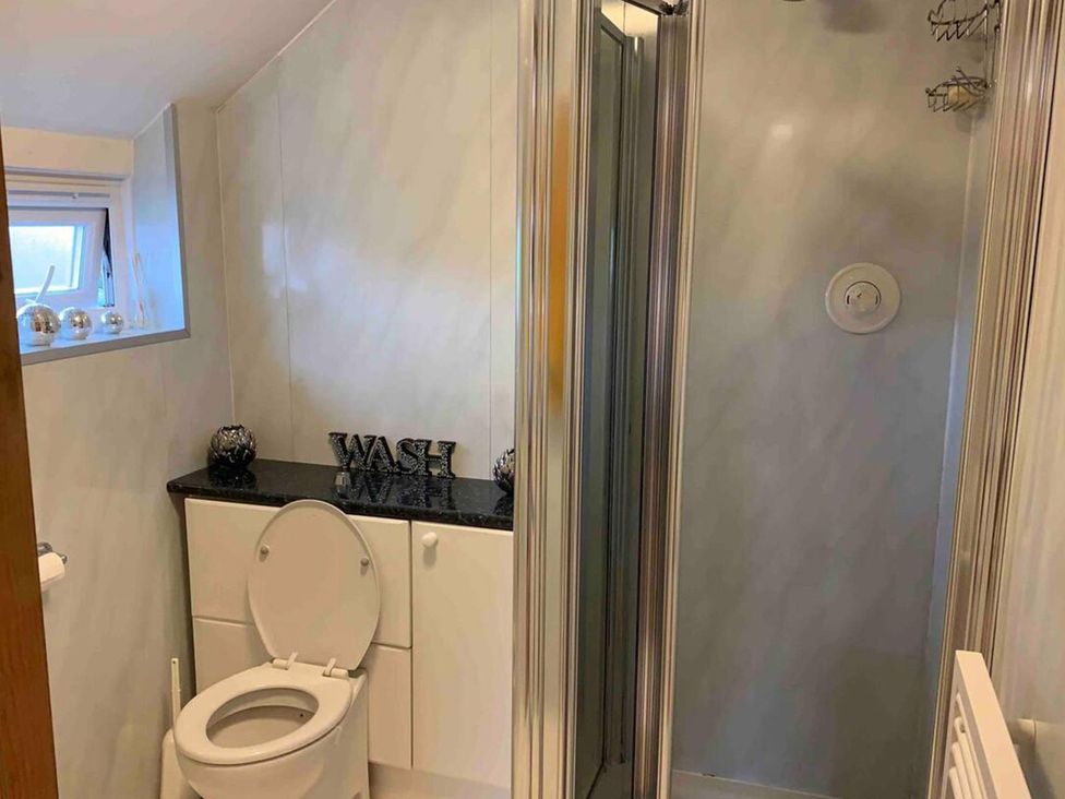 A bathroom with a toilet, shower, and sink at 2Bedroom Cottage with 2 Ensuites Sleeps 6 Wifi Near Rye