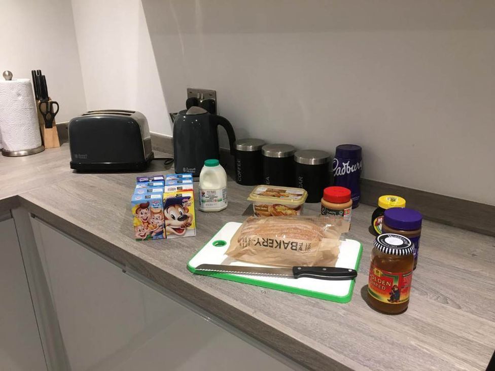 A kitchen counter with various food items and utensils at Family Friendly Apt Sleeps 6 Station Close Royal Tunbridge Wells