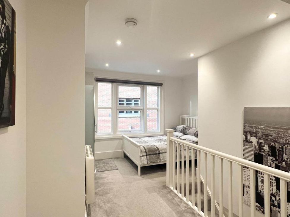 A bedroom with two beds and a window at Family Friendly Apt Sleeps 6 Station Close Royal Tunbridge Wells